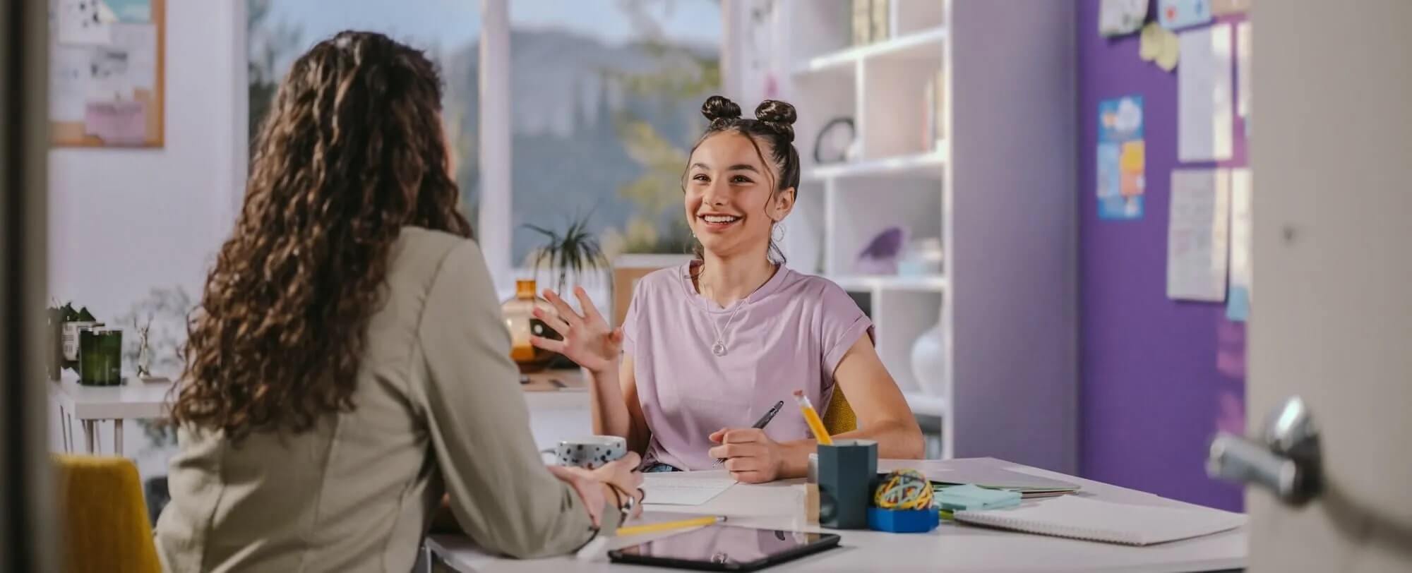 Student studying with her teacher