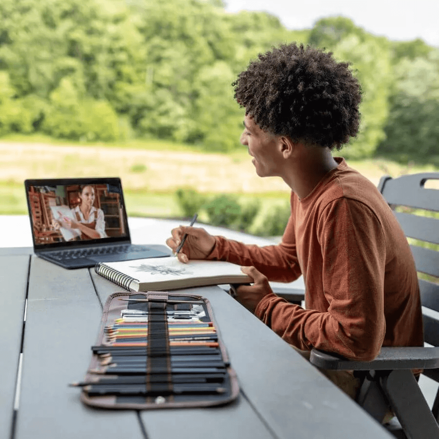 Student studying outside at table