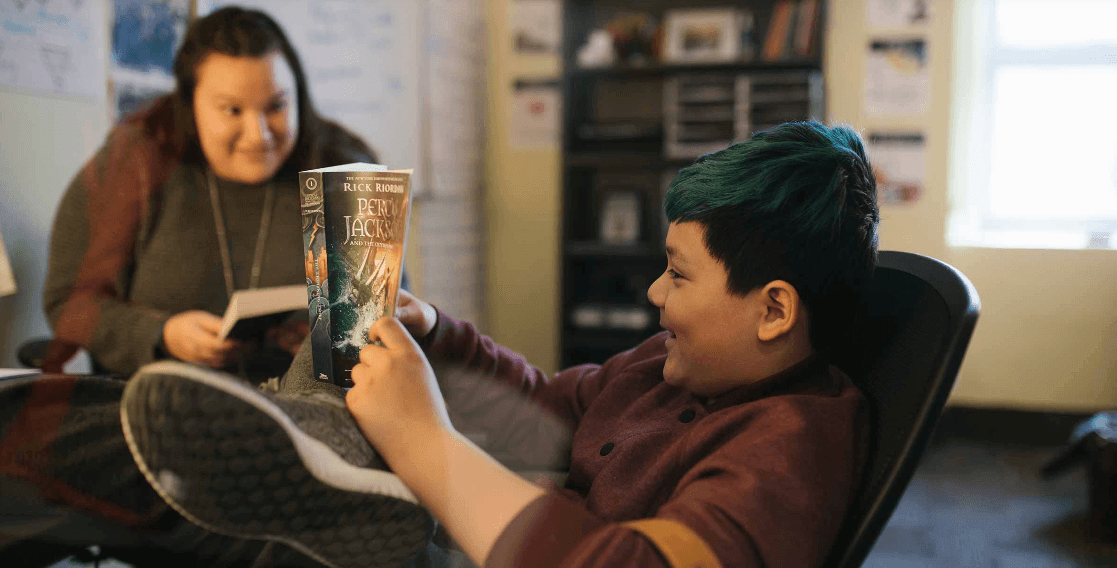 Student reading with teacher