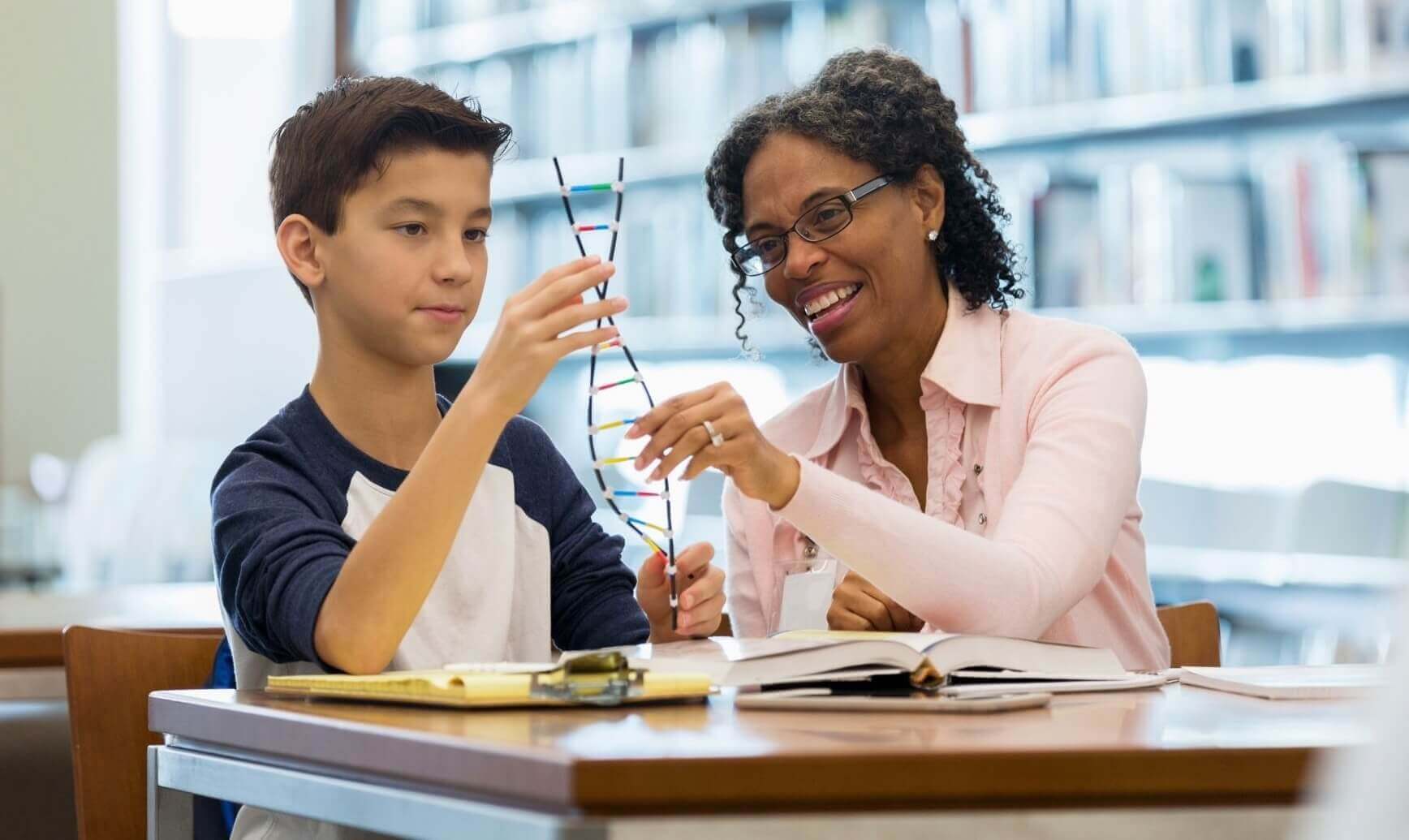 Student and teacher studying science